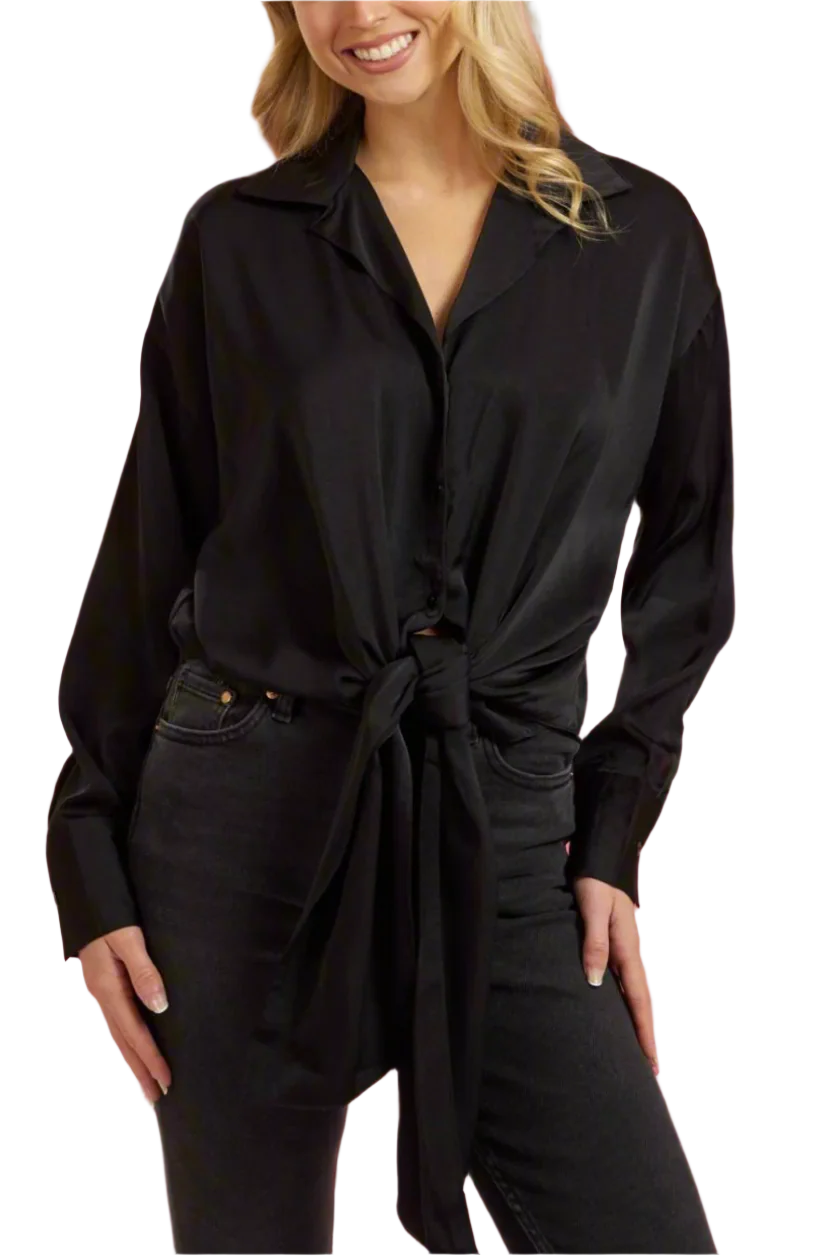 Woman wearing a black shirt with a tie waist against a gray background