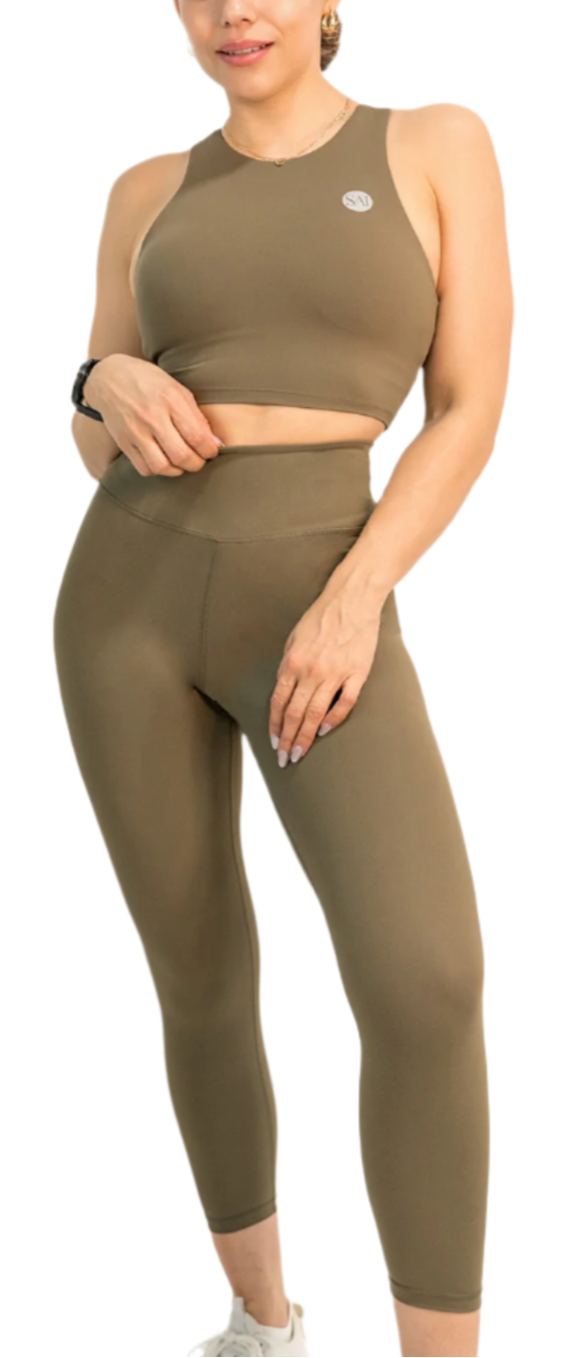 Woman wearing a green athletic outfit on a white background