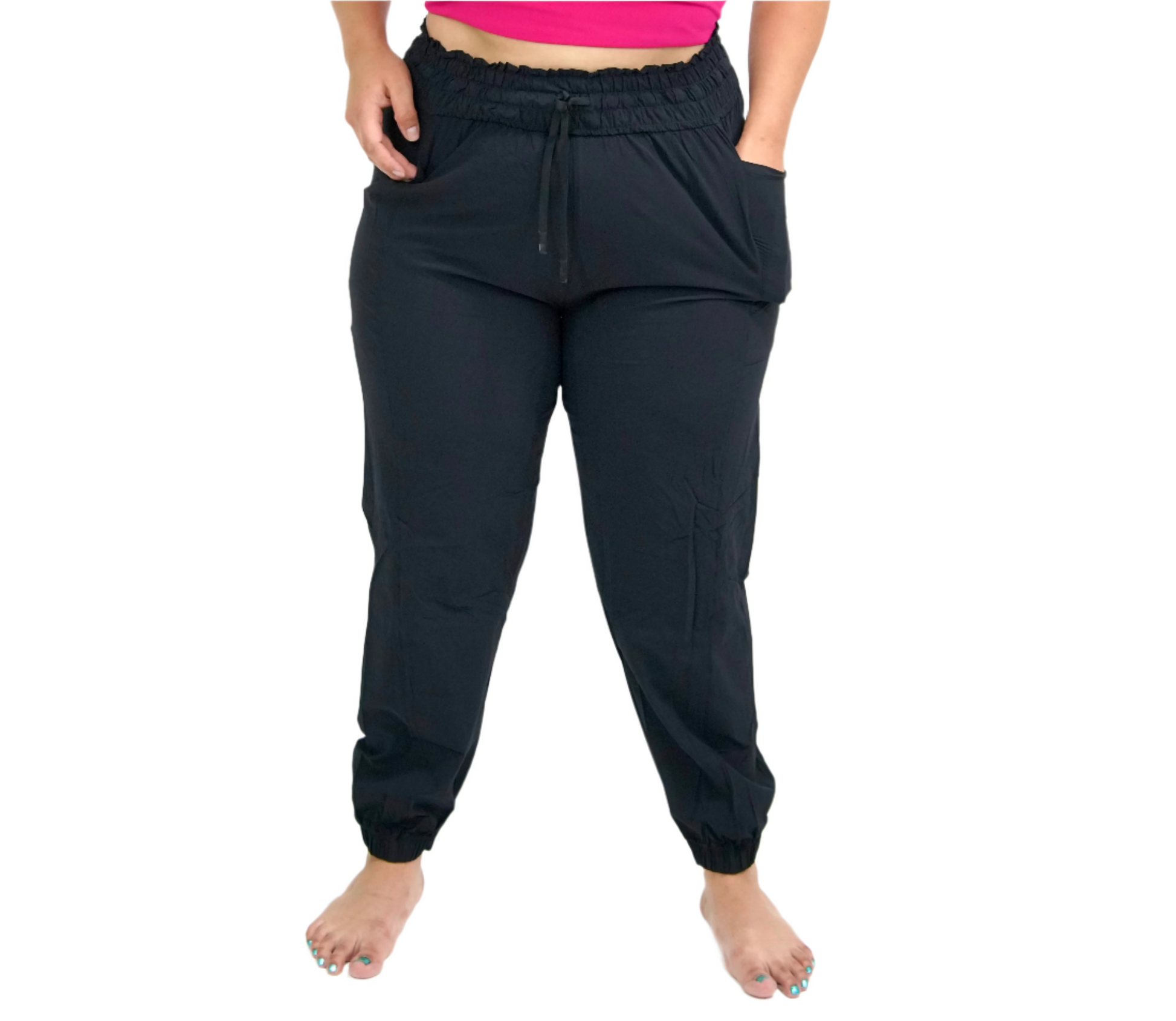 A pair of black relaxed joggers with a drawstring waist, featuring side pockets below the waistband.
