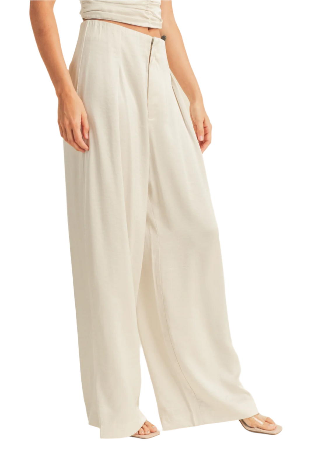 Beige wide-leg pants worn by a person on a white background