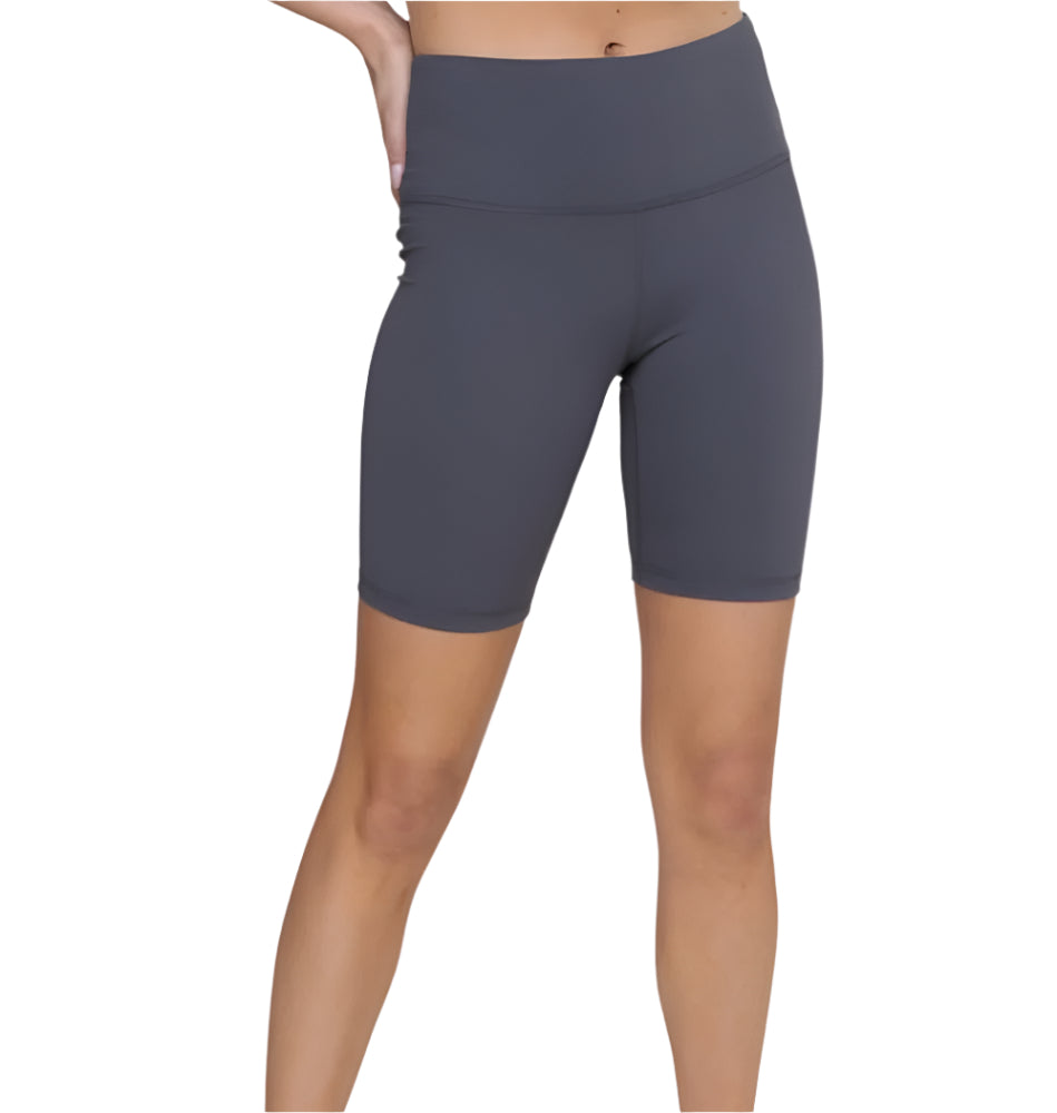 A pair of high-waisted gray biker shorts on a female model, designed for physical activity with a high waistband.