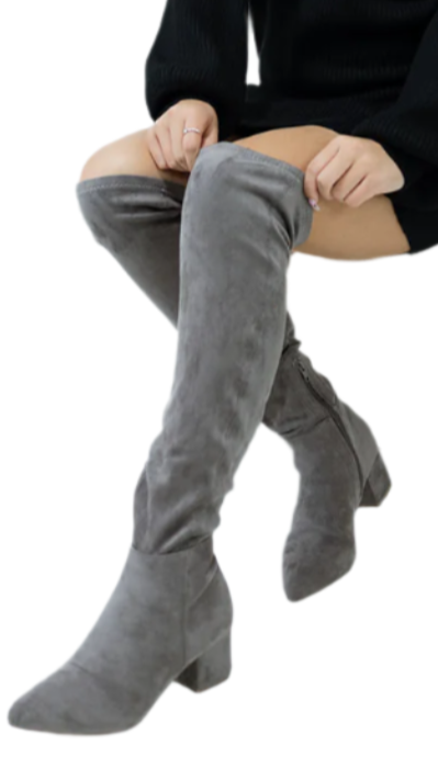 Person wearing a black outfit and gray knee-high boots on a white background