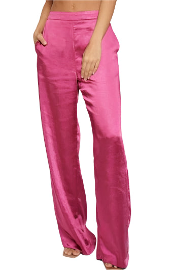 A model wearing pink satin trousers with an elastic waistband and side pockets, standing against a white background.