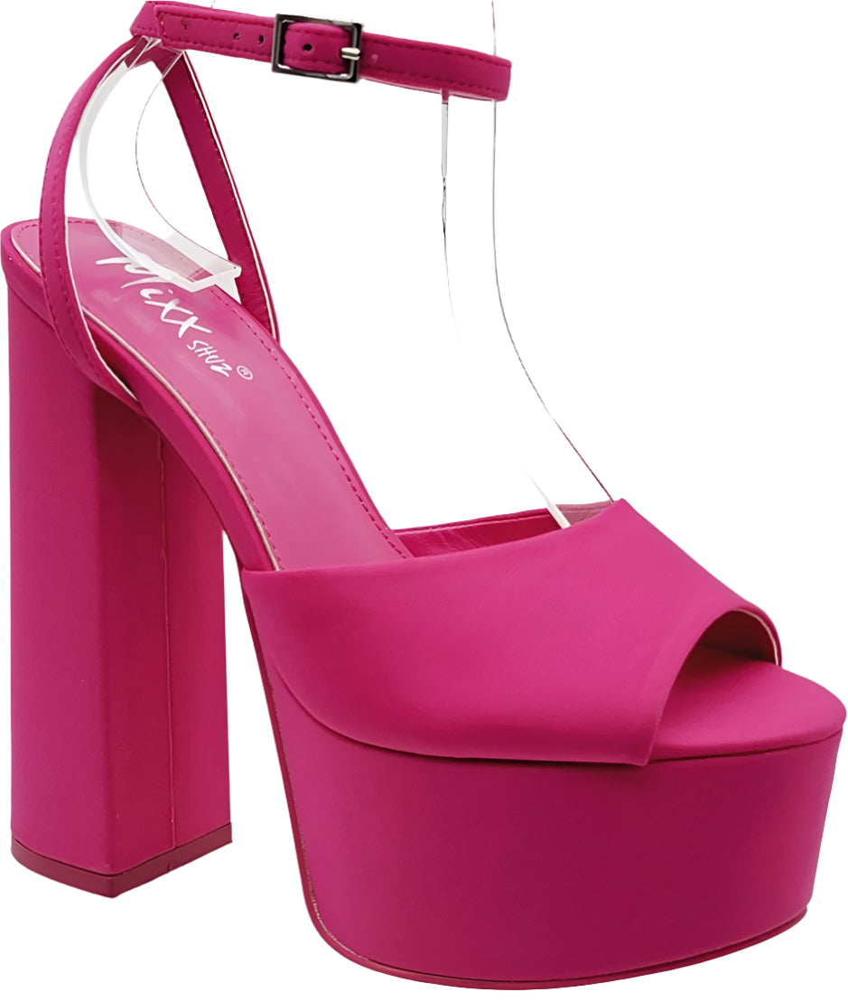 A pair of pink open-toe platform heels with a block design and a visible brand name on the strappy strap.