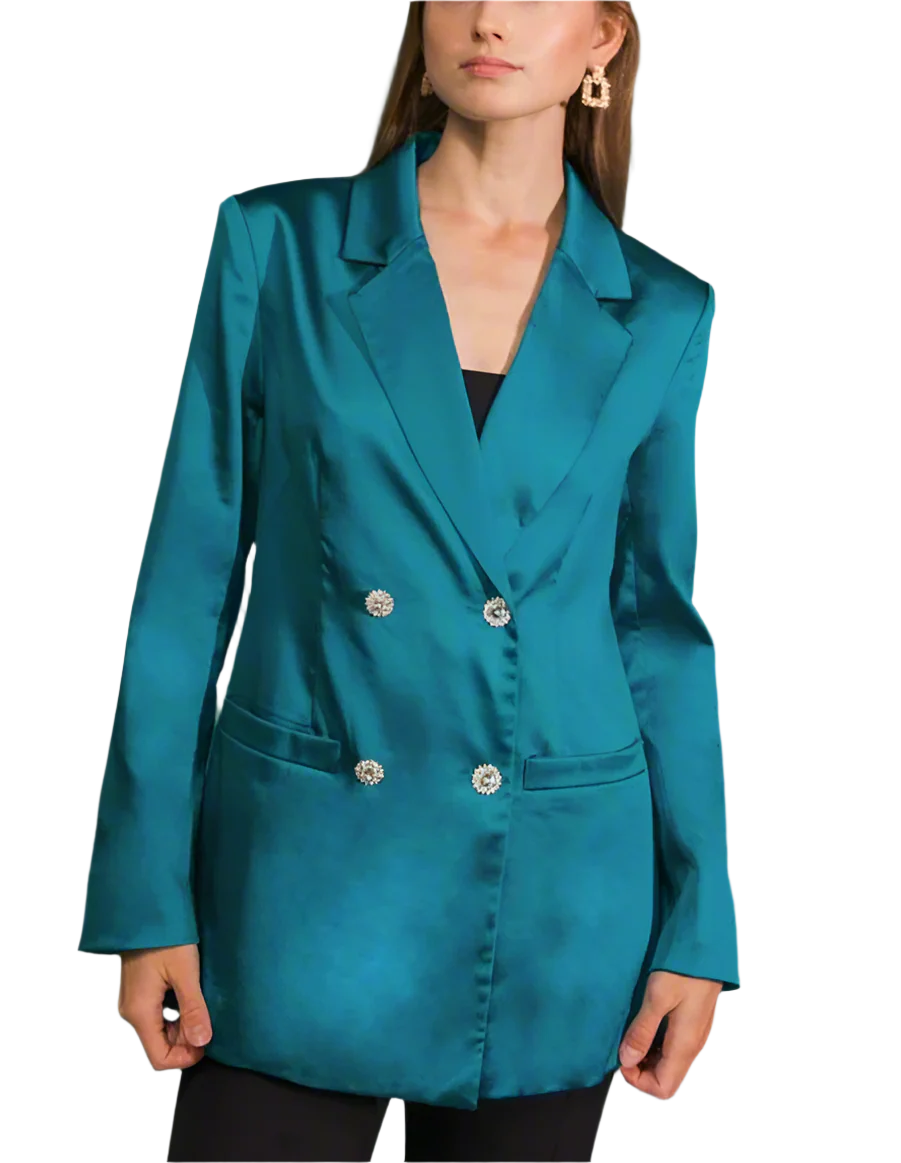 Teal blazer with silver buttons worn by a person on a plain background