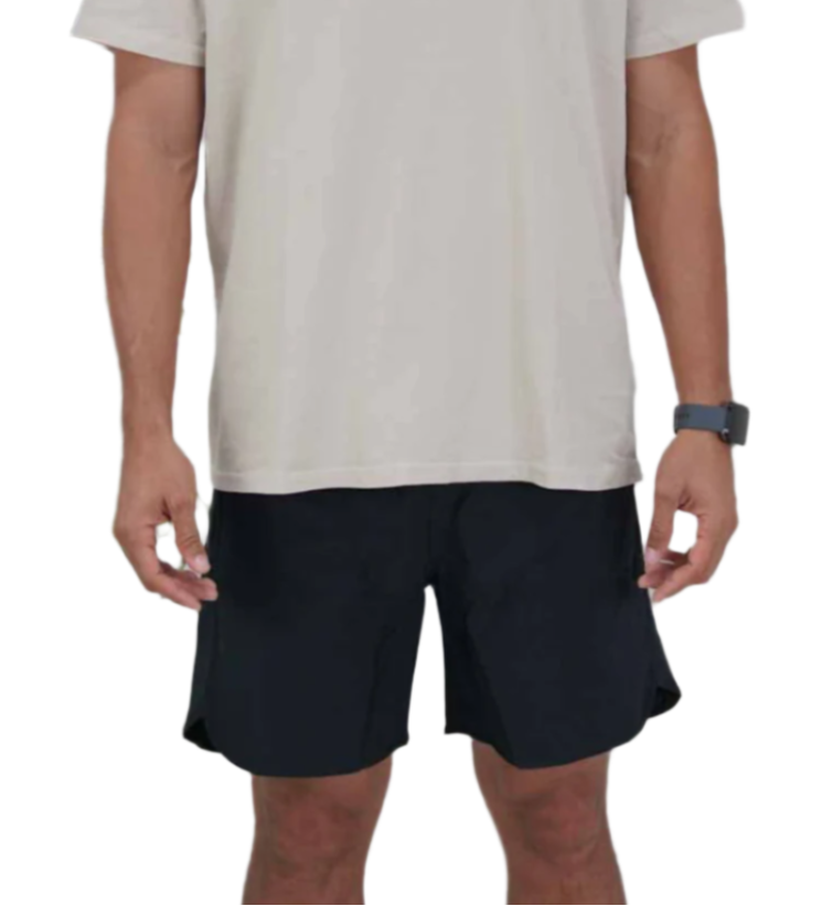 Person wearing black shorts and a beige shirt on a white background