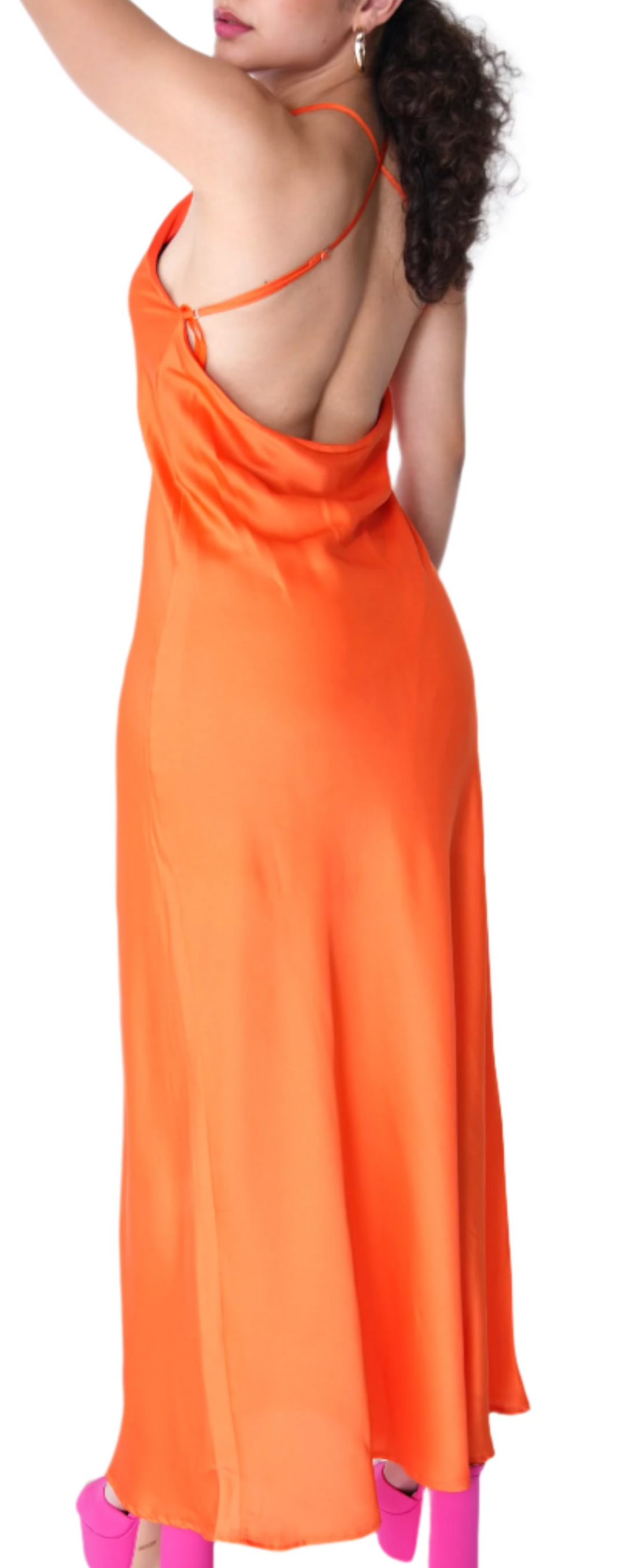 Woman wearing an orange satin dress with a white background.