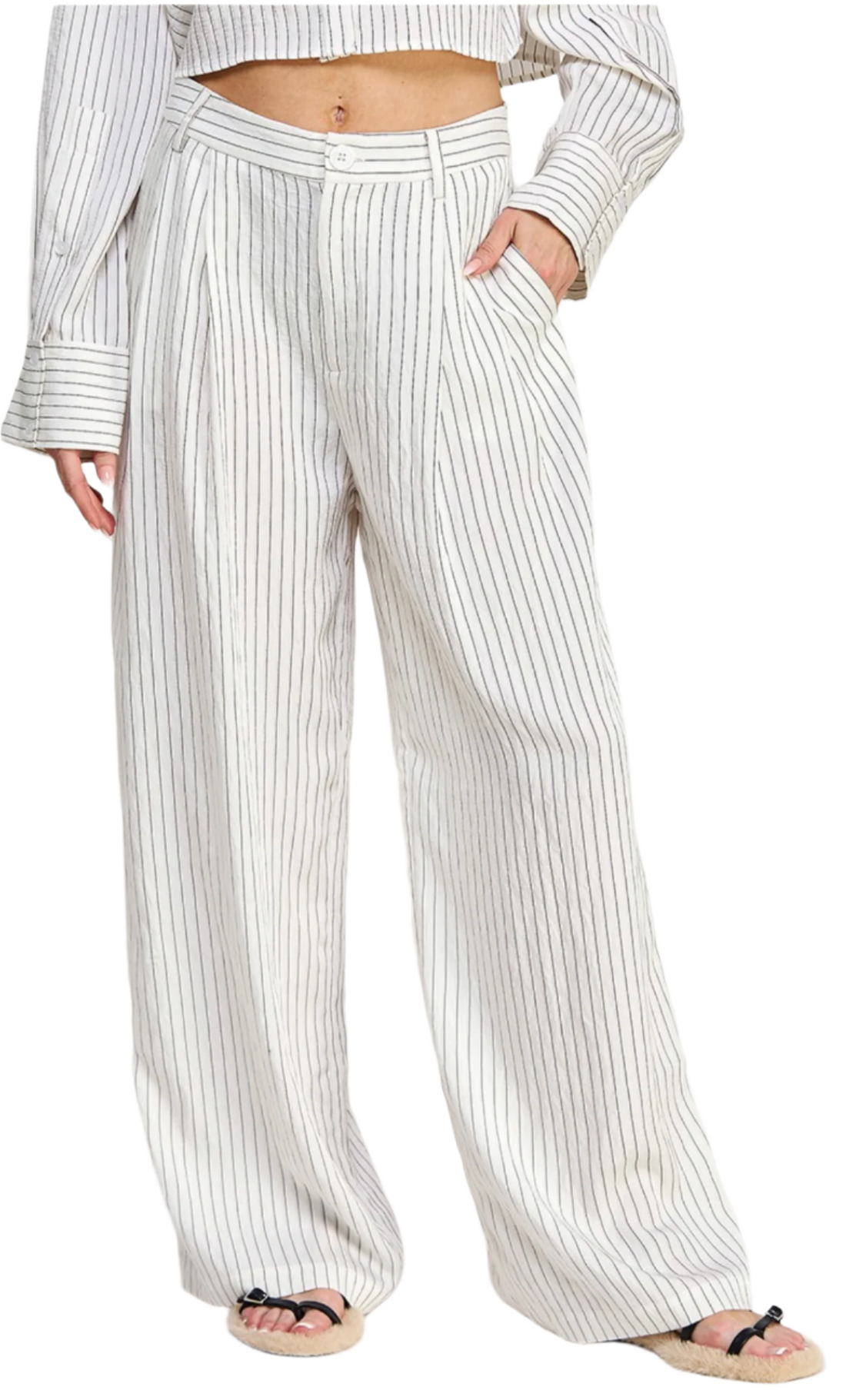 A model wearing full-length men's pants with black lines on a white background, standing against a white background.