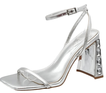 A pair of silver block heel sandals with tubular straps and a square toe, on a white background.