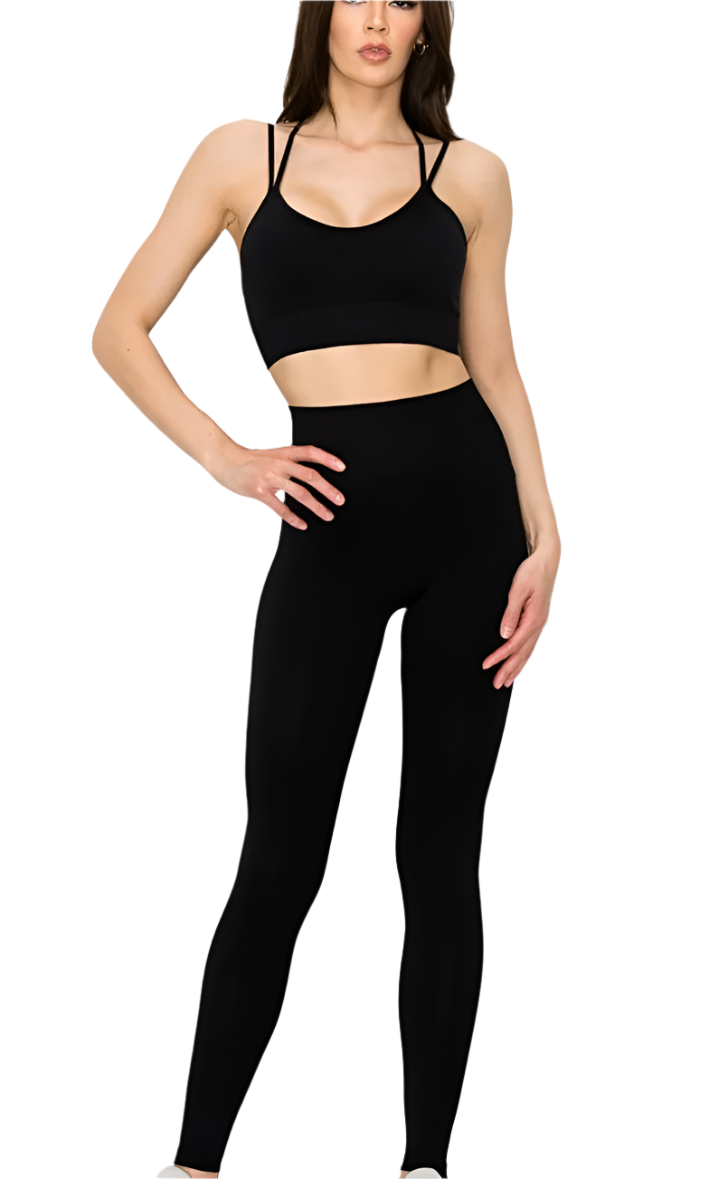 A model wearing a black seamless high stretch camisole active set with matching leggings.