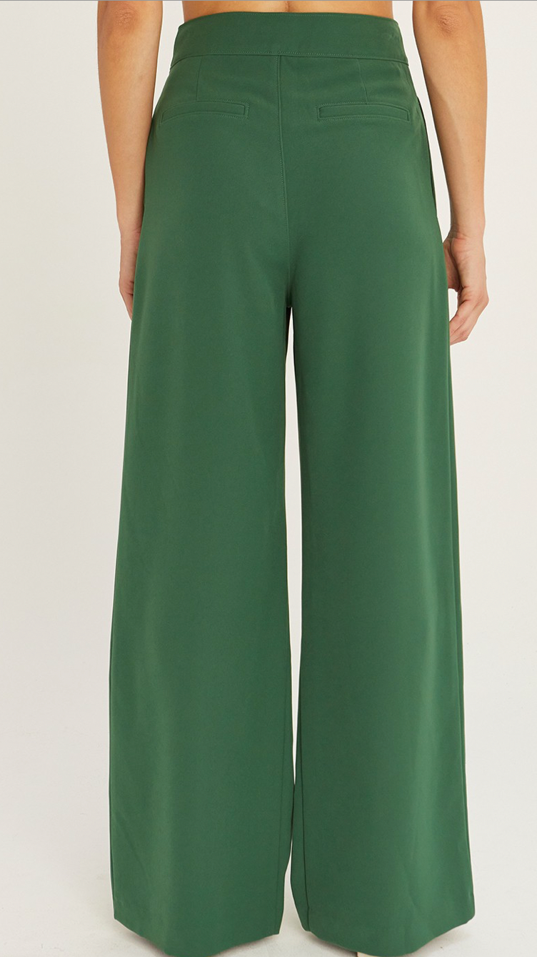 A pair of forest green straight-leg pleated trouser pants with a clean finished interior.