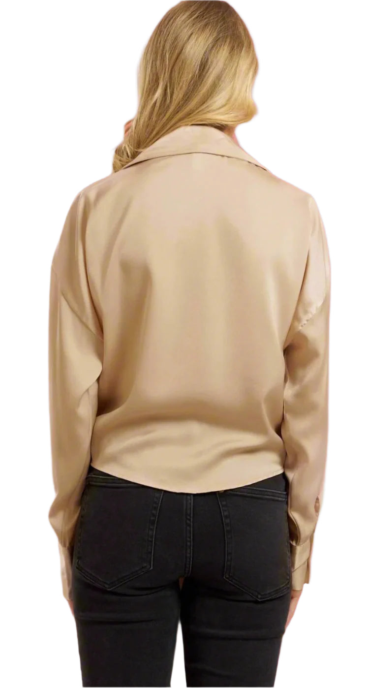 Person wearing a beige jacket on a pink background